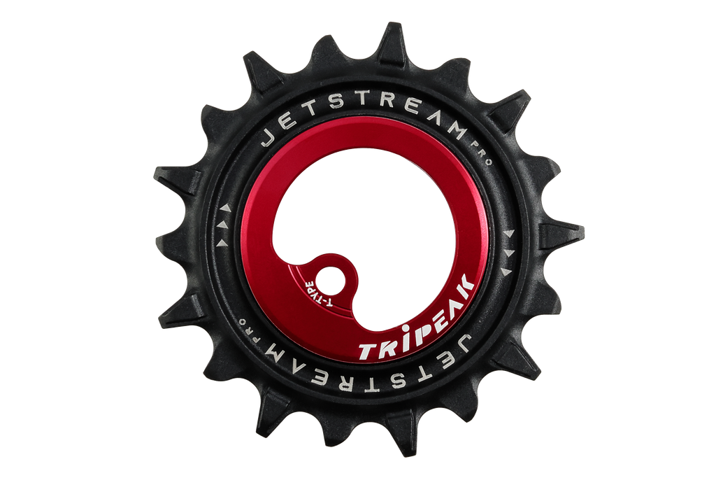 A bicycle chainstay pulley with a black outer sprocket and a red center hub featuring white 'JETSTREAM PRO' and 'TRIPEEK' branding.