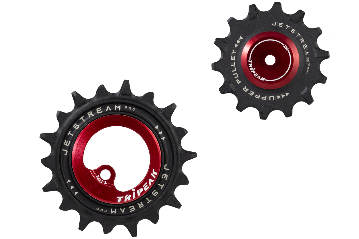Two bicycle chaintensioner pulleys from Tripeak Jetstream Pro 2, featuring a black outer sprocket body and a red anodized center hub with white branding.