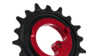 A close-up of a bicycle chainring with a black outer sprocket and a bright red inner ring, shown on a plain white background.