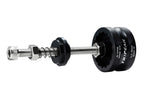 A metal and black mechanical tool with a threaded rod, hex nut, spring, and two circular end pieces, one of which is black and printed with the brand name 'TRIPEAK'.