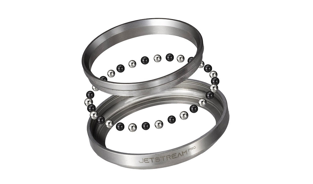 Two metallic bearing rings with rows of small black and silver balls, shown on a plain white background. The lower ring has the text 'JETSTREAM PRO' printed on it.