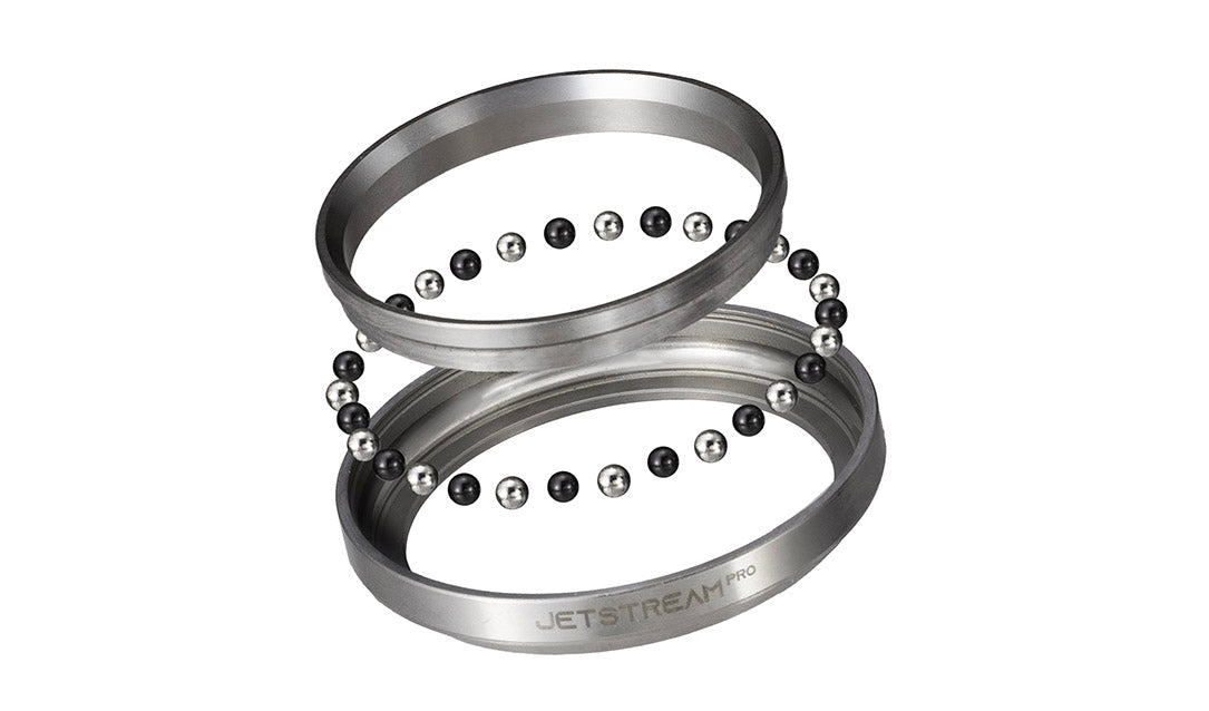 Two metallic bearing rings with rows of small black and silver balls, shown on a plain white background. The lower ring has the text 'JETSTREAM PRO' printed on it.